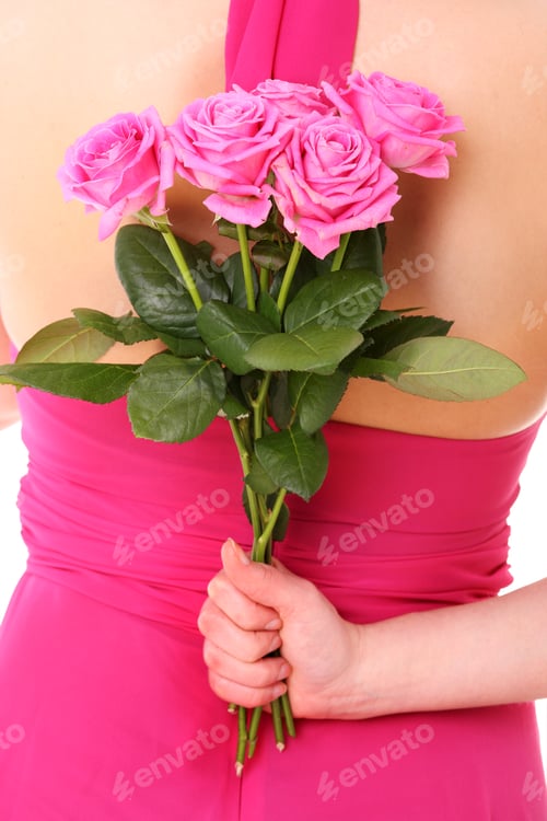 Preview: Woman in pink dress holds pink roses