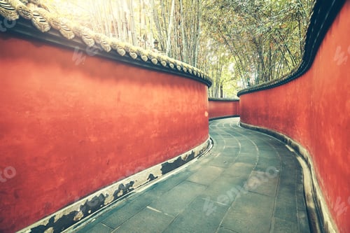 Preview: Curvy red walls passage surrounded by bamboo forest.