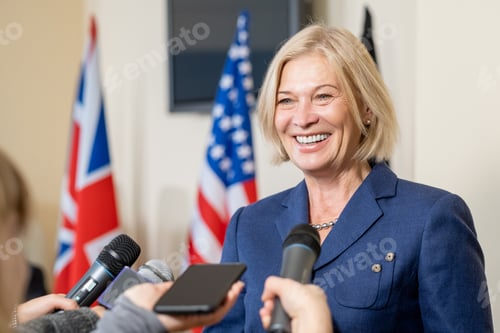 Preview: Smiling Female Politician Talking To Press