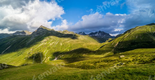 Preview: Scenic landscape featuring green mountains and blue sky. Silvretta High Alpine Road, Switzerland.