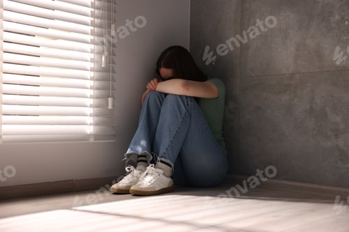 Preview: Woman suffering from paranoia near window at home