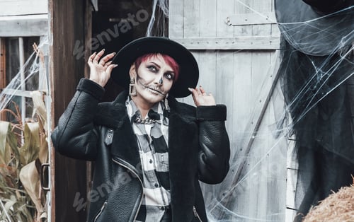 Preview: Scary woman, girl celebrating halloween.Terrifying black skull half-face skeleton makeup and witch c