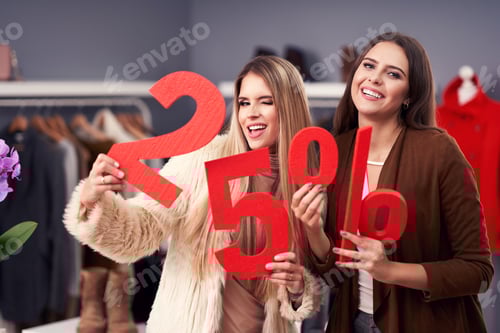 Preview: Adult women shopping for sale in boutique in autumn