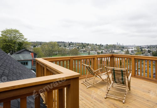 Preview: Wooden house balcony looking out over urban area.