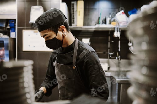 Preview: Chef man working at kitchen.