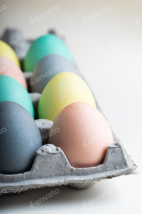 Preview: Easter eggs painted in delicate Easter colors in a table setting with dried flowers