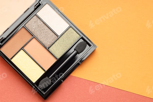 Preview: Beautiful eyeshadow palette and brush on color background, top view. Space for text