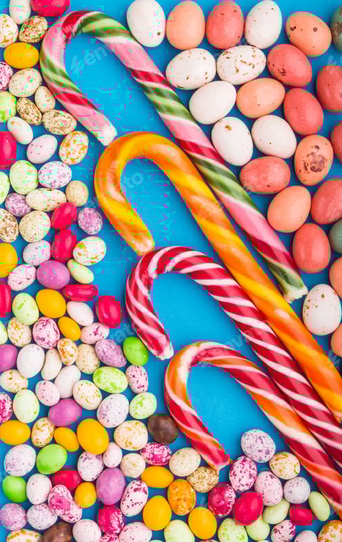 Preview: Colorful multicolored candies on a blue background. top view.