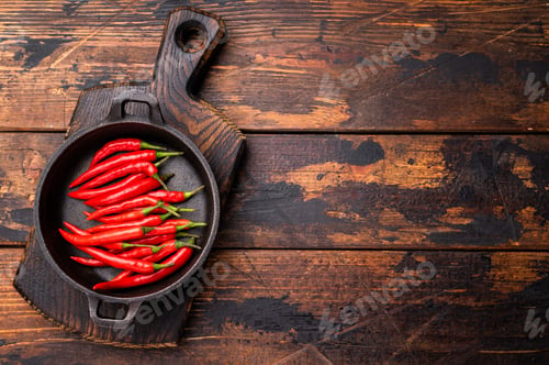 Preview: Freah Red chili peppers in a skillet isolated on white background. top view