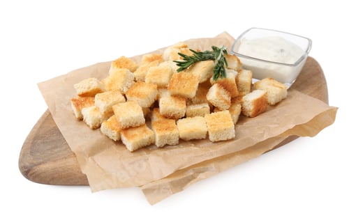 Preview: Delicious crispy croutons with rosemary and sauce on white background