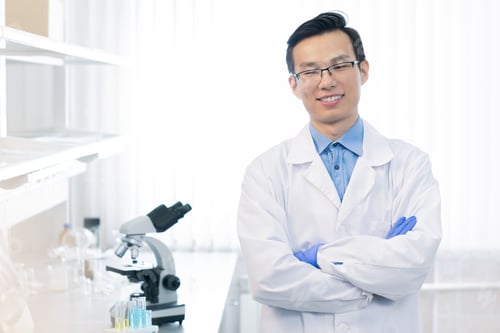 Preview: Happy young Chinese chemist or reseacher with arms crossed by chest