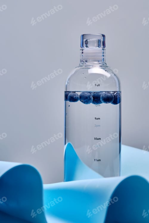 Preview: A glass bottle of pure water with blueberries.