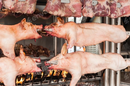 Preview: Carcasses of pork and other meat prepared on skewer.
