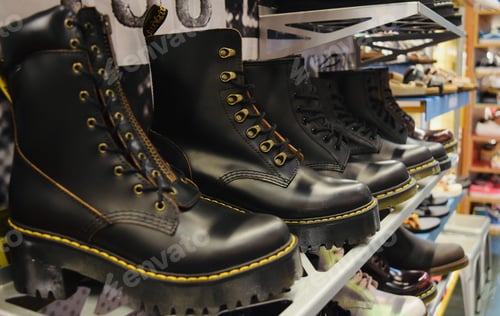 Preview: Closeup shot of black lace-up punk boots with high thick heels on the store display