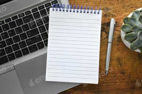 Preview: Blank lined notebook & pen on laptop computer on desk workspace - mock up copy space text overlay