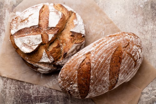 Preview: Assortment of baked bread on wooden table background.