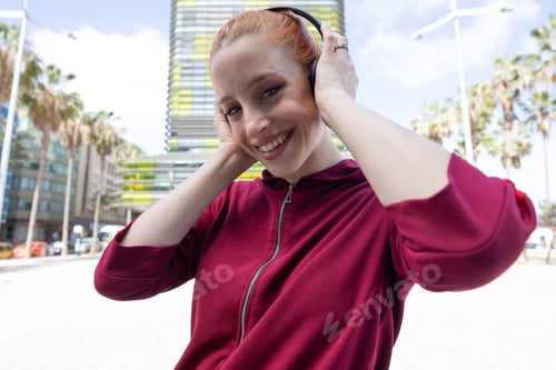 Preview: Close-up portrait of Young red-haired woman with headphones