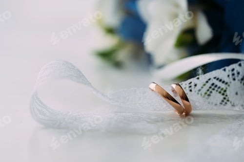 Elegant Wedding Rings on Delicate White Lace