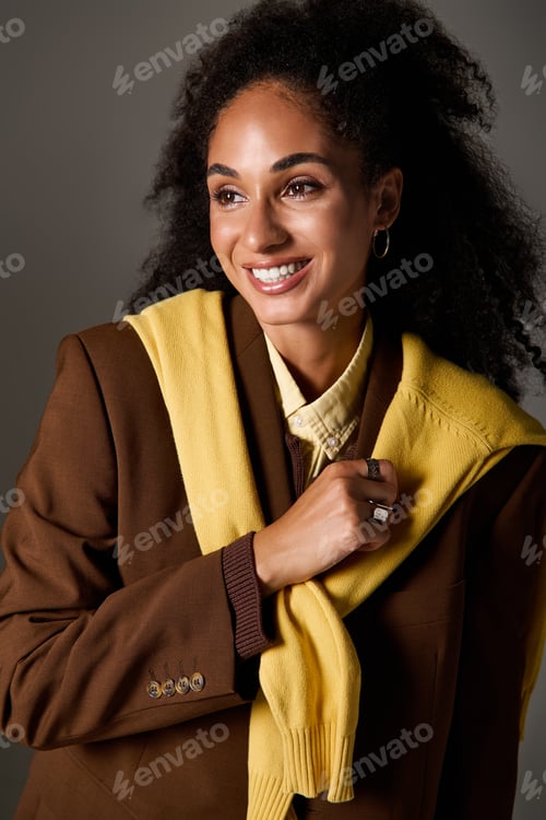 Preview: Trendy autumn style showcased by a confident African American woman in a studio