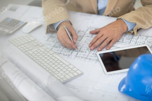 Preview: Cropped view of man writing on blueprint