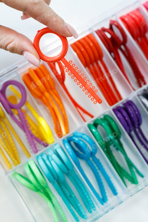 Preview: Colored elastic orthodontic bands for braces. Dentistry. Orthodontic treatment of teeth.