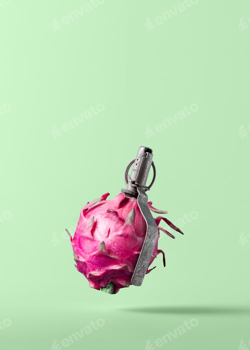 Preview: Creative image of a pink dragon fruit shaped like a grenade against a light green background