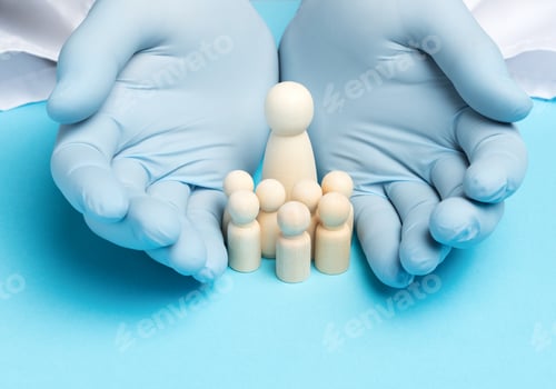 Preview: Two male hands in blue latex gloves and wooden figurines of a woman with children