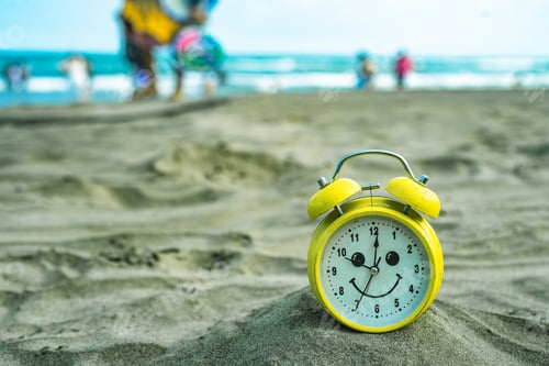 Preview: yellow clock on the beach vacation fun