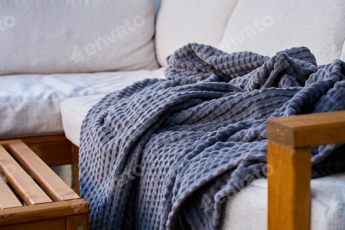 Preview: Wooden outdoor sofa with blanket on patio terrace