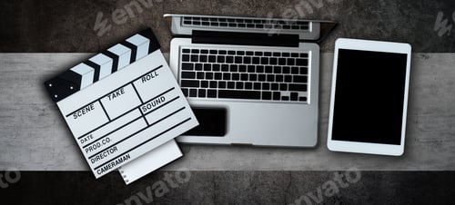 Preview: office stuff with Movie clapper, laptop, smartphone, tablet, coffee cup, pen, notepad and documents
