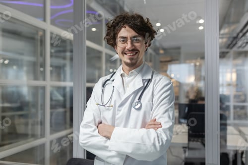 Preview: Male Doctor With Crossed Arms and Stethoscope in Medical Office
