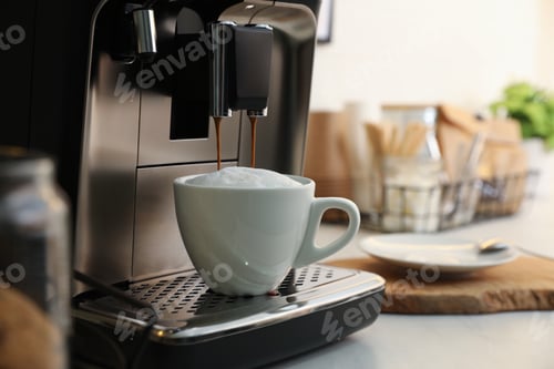 Preview: Modern coffee machine making cappuccino in kitchen, space for text