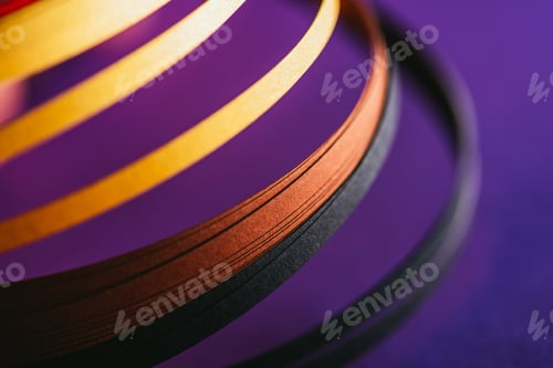 Preview: close up of yellow and black quilling paper curves on purple