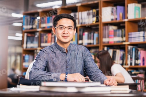 Preview: Portrait Asian teacher sitting in the library and classroom, University education, back to school