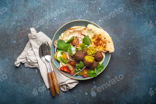 Preview: Middle Eastern Arab meal with fried falafel, hummus, vegetables salad, pita bread