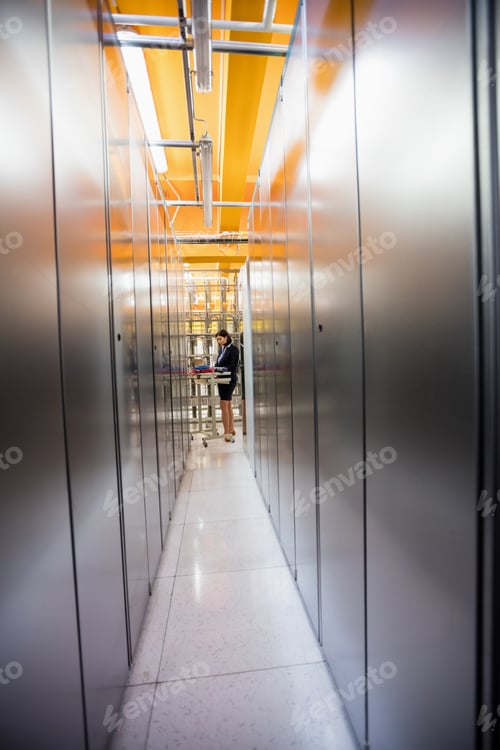Preview: Technician Working In Hallway Of Server Room