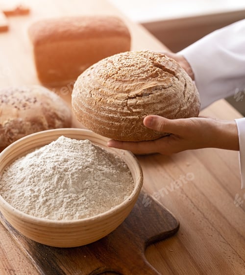 Preview: Crop baker carrying bread near flour