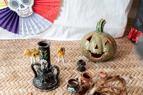 Preview: A ceramic gourd next to other adornments decorating a Day of the Dead sleeping mat