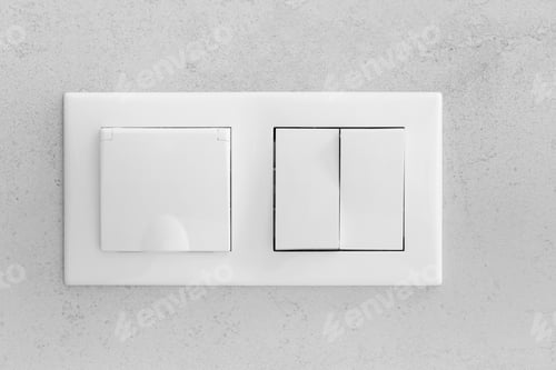 Preview: Closed socket and switch on the wall in the bathroom