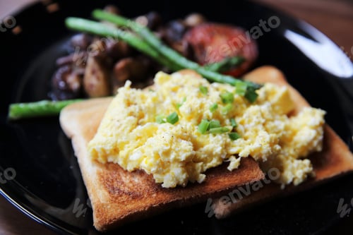 Preview: Scrambled Egg With Bread And Mushroom On Wood Background