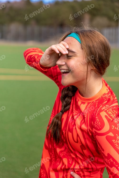 Preview: Girl soccer player. Girl in sports uniform on the soccer field. Football concept.