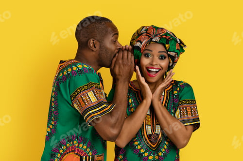 Preview: Black man sharing secrets with girlfriend, african couple on yellow