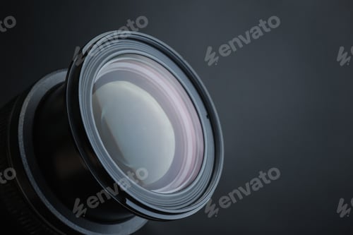 Preview: Lens of professional camera on black background, closeup. Space for text