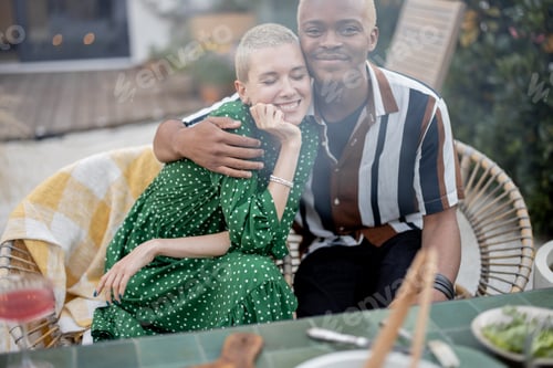 Preview: Man hugging his european girlfriend at backyard