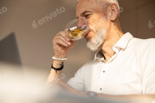 Preview: Remote worker is tasting a delicious tea
