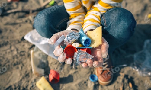 Preview: Child hands with garbage from the beach