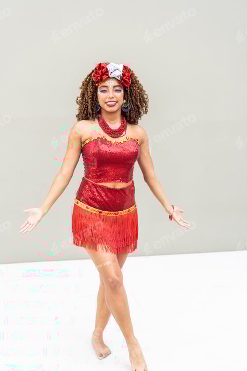 Preview: Woman dancing in a red carnival costume with festive makeup