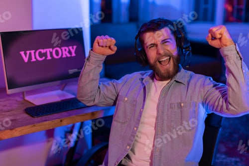 Preview: Triumphant gamer with winning screen in neon light