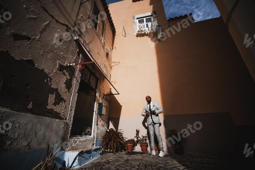 Preview: Black guy in a residential courtyard