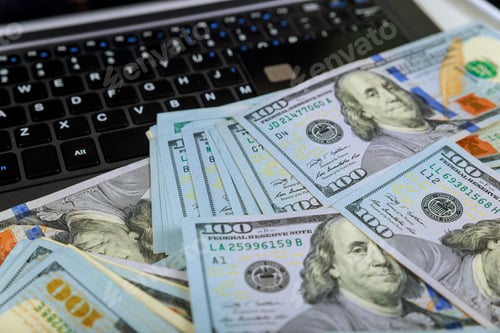 Preview: Credit cards and dollars on a laptop, close-up view a using contactless payment